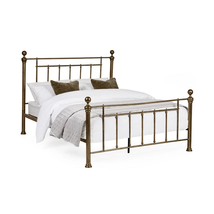 Aurelia bed frame in brass effect finish with slender metal bars and rounded finials