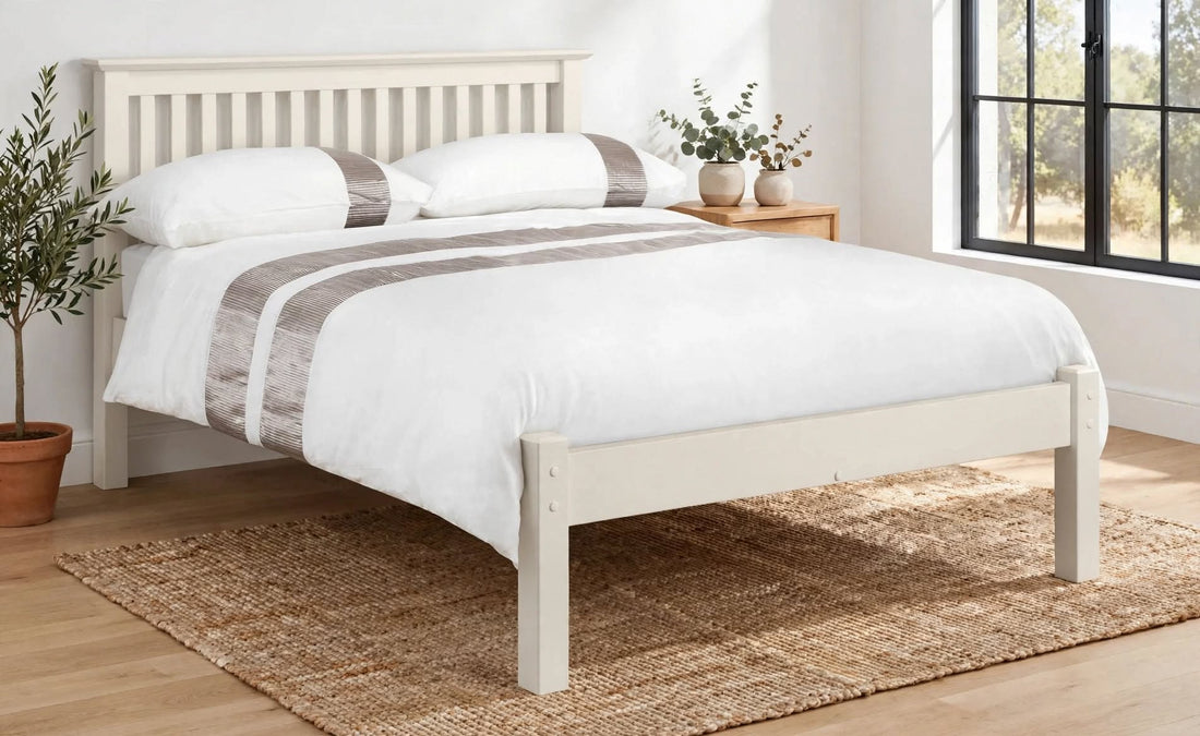 Barcelona Low Foot End Bed in Stone White lacquer with shaker style headboard white bedding with taupe stripe pillows made up front angled view - St James Beds