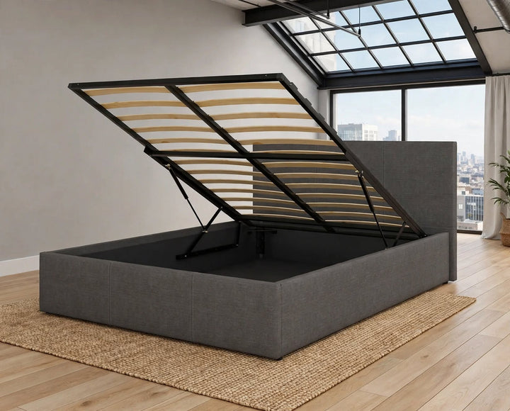 Grey ottoman lift-up storage bed in light grey linen fabric open position showing slatted base black metal frame hydraulic mechanism tall headboard - St James Beds