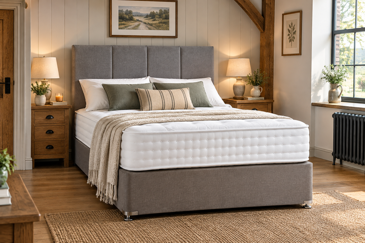 Grey upholstered bed with white mattress styled in a cosy farmhouse bedroom – St James Beds.