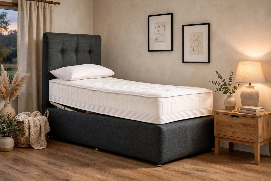 Motion Memory adjustable bed with blue grey headboard and memory foam mattress on white background - St James Bed Centre