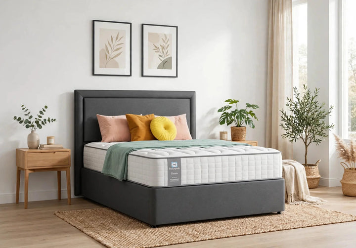 Sealy Posturepedic Elevate Emin Firm mattress on grey divan base at St James Bed Centre King's Lynn